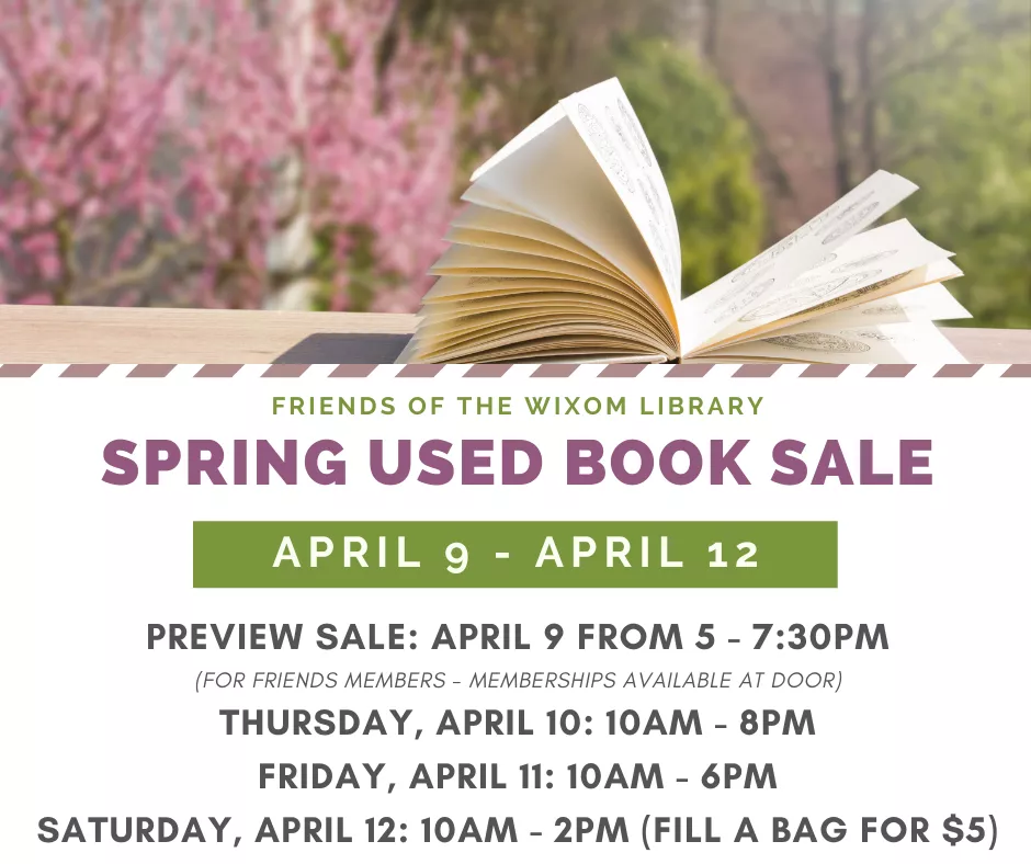 open book on table with spring flowers in the background